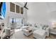 Bright living room features a fireplace, modern ceiling fan, and balcony with marina views at 1948 Marsh Oak Ln, Seabrook Island, SC 29455