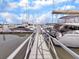 Daytime view of a marina with docked boats over the wooden gangway on a clear day at 1948 Marsh Oak Ln, Seabrook Island, SC 29455