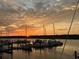 Sunset view of the marina, with boats docked and orange skies reflected in the water at 1948 Marsh Oak Ln, Seabrook Island, SC 29455