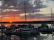 Sunset view of sailboats and yachts docked at the marina, reflecting in the water at 1948 Marsh Oak Ln, Seabrook Island, SC 29455