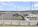 Daytime view of a full marina with boats docked at the end of wooden gangway over calm waters at 1948 Marsh Oak Ln, Seabrook Island, SC 29455