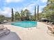 Inviting community swimming pool surrounded by lush greenery and lounge chairs at 1948 Marsh Oak Ln, Seabrook Island, SC 29455