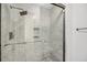 Luxurious shower with stunning marble tile work, glass door, and modern fixtures at 1948 Marsh Oak Ln, Seabrook Island, SC 29455