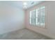 This bedroom features plush carpeting and a window with classic plantation shutters at 2000 Belle Isle Ave # 204, Mount Pleasant, SC 29464