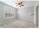 The bedroom features a ceiling fan, window with blinds, and neutral walls at 2000 Belle Isle Ave # 204, Mount Pleasant, SC 29464