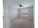This bedroom features plush carpeting and a window with classic plantation shutters at 2000 Belle Isle Ave # 204, Mount Pleasant, SC 29464