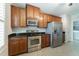 Functional kitchen design includes stainless appliances and ample wood cabinet storage at 2000 Belle Isle Ave # 204, Mount Pleasant, SC 29464