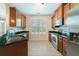 Bright kitchen showcases stainless appliances, dark granite countertops, and wood cabinetry at 2000 Belle Isle Ave # 204, Mount Pleasant, SC 29464