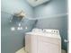 Practical laundry area features white washer/dryer, shelving and neutral paint at 2000 Belle Isle Ave # 204, Mount Pleasant, SC 29464