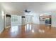 Spacious open-concept living area with hardwood floors and views into a sun room and kitchen at 2000 Belle Isle Ave # 204, Mount Pleasant, SC 29464