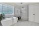 Luxurious bathroom with a modern soaking tub, glass shower, and plenty of natural light from glass block window at 2040 Shell Ring Cir, Mount Pleasant, SC 29466