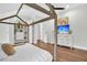 Charming bedroom featuring hardwood floors, ceiling fan, walk-in closet, and a decorative canopy bed frame at 2040 Shell Ring Cir, Mount Pleasant, SC 29466