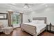 Bedroom with tray ceiling, sitting chair, elegant curtains, and hardwood floors at 2040 Shell Ring Cir, Mount Pleasant, SC 29466