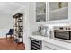A stylish coffee bar with wine fridge, coffee machine and accessories in a modern home at 2040 Shell Ring Cir, Mount Pleasant, SC 29466