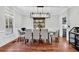 Elegant dining room with stylish chandelier, wood floors, and seating for six at 2040 Shell Ring Cir, Mount Pleasant, SC 29466