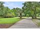 Paver driveway surrounded by lush landscaping, leading to a beautiful home at 2040 Shell Ring Cir, Mount Pleasant, SC 29466
