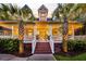 Stunning front exterior showcasing a covered porch, brick stairs, and mature landscaping at 2040 Shell Ring Cir, Mount Pleasant, SC 29466