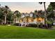 Charming home featuring a classic white porch, red brick steps, and beautifully landscaped yard with palm trees at 2040 Shell Ring Cir, Mount Pleasant, SC 29466