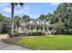 The exterior of this home features a long front porch and tropical trees at 2040 Shell Ring Cir, Mount Pleasant, SC 29466
