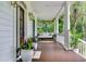Inviting front porch with a porch swing, white columns, and lush greenery at 2040 Shell Ring Cir, Mount Pleasant, SC 29466