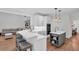 A modern kitchen featuring an island with pendant lighting and seating, open to a cozy living space at 2040 Shell Ring Cir, Mount Pleasant, SC 29466