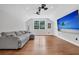 Spacious living room features hardwood floors, a large sectional sofa, and a wall-mounted TV at 2040 Shell Ring Cir, Mount Pleasant, SC 29466