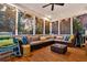 Large, screened in outdoor living space with comfortable seating and views of mature trees at 2040 Shell Ring Cir, Mount Pleasant, SC 29466