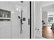 Modern shower featuring white subway tile, black fixtures and glass door at 2040 Shell Ring Cir, Mount Pleasant, SC 29466