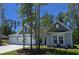 Charming single-story home with gray siding, a three-car garage, and a well-manicured front yard at 243 Darby Meadow Ln, Ridgeville, SC 29472