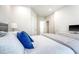 Well-lit bedroom features plush bedding, neutral decor, and hardwood flooring at 260 Seven Farms Dr # 306, Charleston, SC 29492