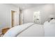 Neutral bedroom featuring a white comforter, hardwood floors, and views into the bathroom at 260 Seven Farms Dr # 306, Charleston, SC 29492