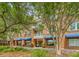 Brick building with blue awnings, mature trees, and landscaped walkway at 260 Seven Farms Dr # 306, Charleston, SC 29492
