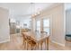 Well-lit dining room with a rustic wooden table and adjacent kitchen area at 260 Seven Farms Dr # 306, Charleston, SC 29492