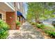 Beautifully landscaped brick building exterior, showcasing a sidewalk lined with plants and shade trees at 260 Seven Farms Dr # 306, Charleston, SC 29492