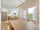 Bright, open kitchen with stainless steel appliances, island seating, and door to balcony at 260 Seven Farms Dr # 306, Charleston, SC 29492