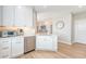Bright kitchen features white cabinetry, stainless appliances, and light wood flooring at 260 Seven Farms Dr # 306, Charleston, SC 29492
