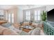 Bright living room with neutral tones, plantation shutters, and comfortable seating at 260 Seven Farms Dr # 306, Charleston, SC 29492