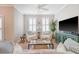Bright living room features stylish seating, modern TV, and charming decor at 260 Seven Farms Dr # 306, Charleston, SC 29492