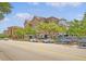Charming street view with brick buildings, mature trees, street parking, and inviting outdoor cafe seating at 260 Seven Farms Dr # 306, Charleston, SC 29492
