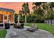 A spacious backyard featuring a palm tree, patio, well-manicured lawn, and a screened-in porch at 2720 Oak Manor Dr, Mount Pleasant, SC 29466