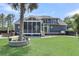 Expansive backyard with lush lawn, screened porch, and beautiful landscaping offers serene outdoor living at 2720 Oak Manor Dr, Mount Pleasant, SC 29466