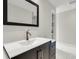 Bathroom featuring a sleek vanity with a modern faucet, white marble floors, and an elegant mirror at 2720 Oak Manor Dr, Mount Pleasant, SC 29466