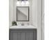 Modern bathroom with a gray vanity, decorative mirror, and crisp white walls at 2720 Oak Manor Dr, Mount Pleasant, SC 29466