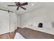Bright bedroom featuring a ceiling fan, hardwood floors, and a stylish sliding barn door at 2720 Oak Manor Dr, Mount Pleasant, SC 29466