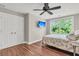 Comfortable bedroom with wood floors, a ceiling fan, and a large window overlooking trees at 2720 Oak Manor Dr, Mount Pleasant, SC 29466