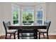 Bright dining area featuring a wooden table with large windows, creating a warm and inviting space at 2720 Oak Manor Dr, Mount Pleasant, SC 29466