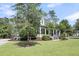 Gorgeous home boasting a classic porch, lush yard, and mature trees creating a picturesque setting at 2720 Oak Manor Dr, Mount Pleasant, SC 29466