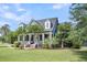 Stately home with a charming front porch, well-manicured lawn, and mature landscaping for curb appeal at 2720 Oak Manor Dr, Mount Pleasant, SC 29466