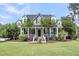 Attractive home with a welcoming front porch, green lawn, and well-maintained landscape at 2720 Oak Manor Dr, Mount Pleasant, SC 29466