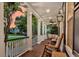 Inviting front porch features brick flooring, rocking chairs, and outdoor ceiling fans at 2720 Oak Manor Dr, Mount Pleasant, SC 29466